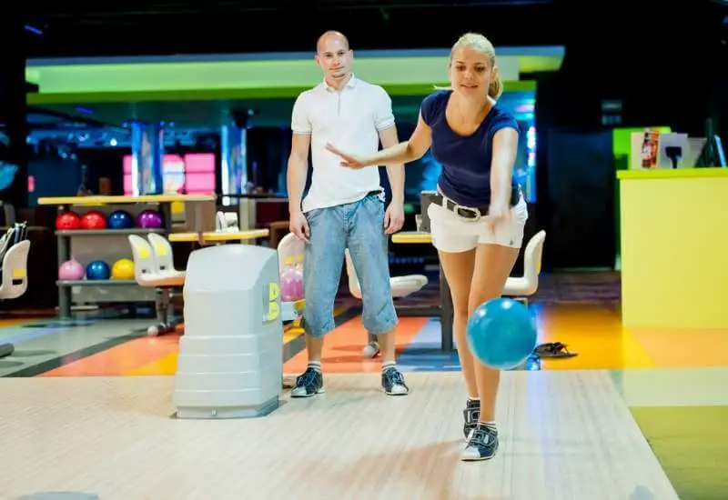 A couple playing bowling
