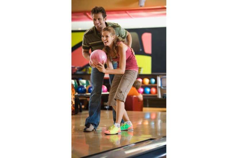 A couple playing bowling

